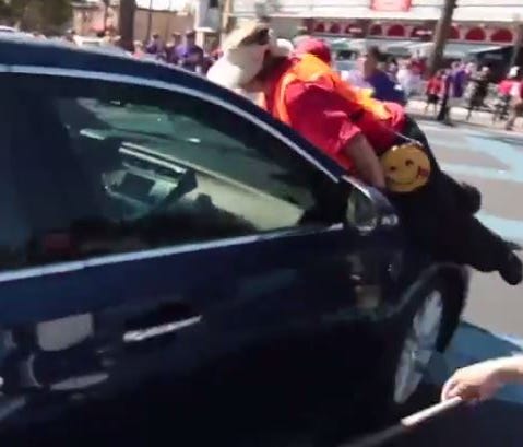 A demonstrator in Brea, Calif., after jumping on the hood of a car moving through a crowd