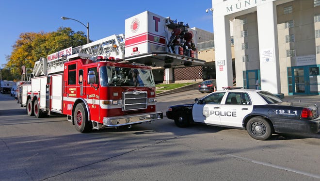 A Milwaukee fire truck and a Milwaukee police car.