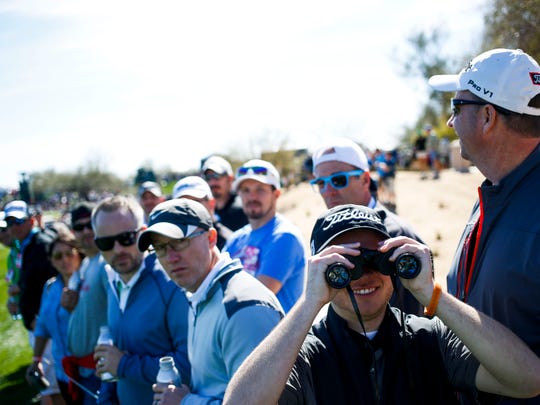 Brock Jensen peers through binoculars on the second