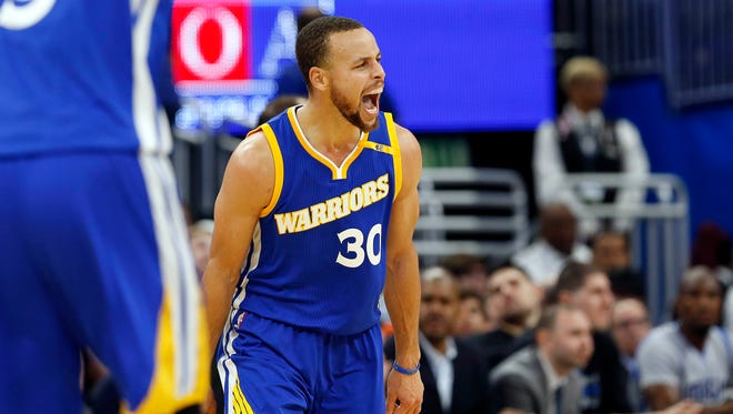 Golden State Warriors guard Stephen Curry (30) reacts after he makes a three pointer against the Orlando Magic during the second half at Amway Center.