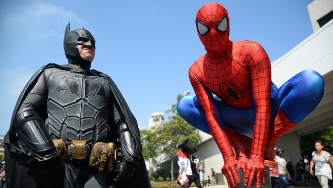 Dorian Black, left, dressed as Batman and Kyle Blankenfield as Spiderman on day 3 of Comic-Con International on Saturday, July 23, 2016, in San Diego.