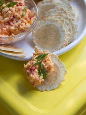 
Zesty pimiento cheese is served. Pimiento (also often spelled pimento) dates to at least the late 1800s, when the blend of pimientos (a sweet pepper) and cheese was served at formal gatherings. It quickly became a staple for the working man because it didn’t require refrigeration.
