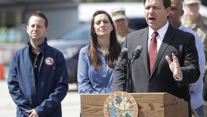 Florida Gov. Ron DeSantis, right, speaks during a news conference alongside Lt. Gov. Jeanette Nunez, center, and Jared Moskowitz, then director of Florida’s Division of Emergency Management