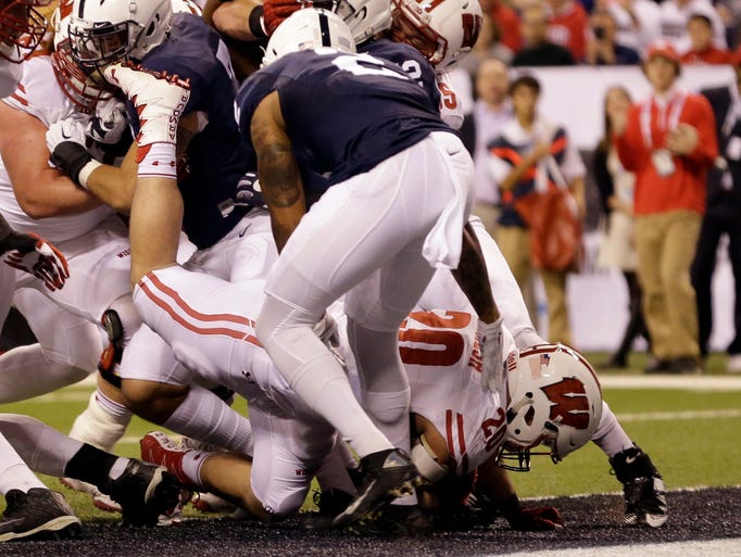 Wisconsin fullback Austin Ramesh, bottom, scores on