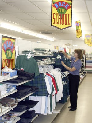 In this 2006 Post-Crescent Media file photo, Peggy Edmonds works in her store, King's Variety  in Little Chute.