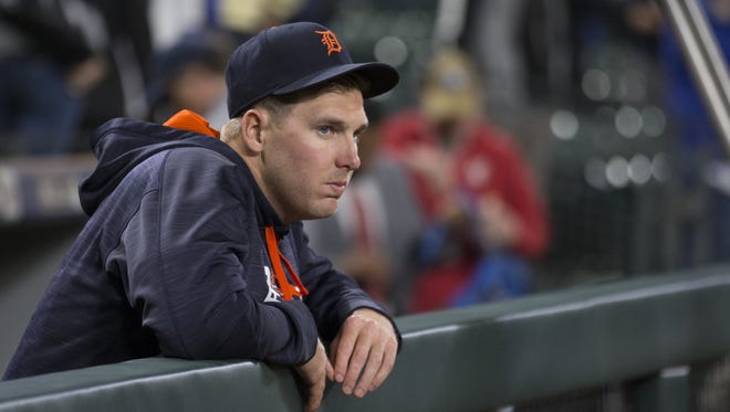 Relief pitcher Daniel Stumpf #68 of the Detroit Tigers watches from the dugout as the Seattle Mariners celebrate after game at Safeco Field on June 20, 2017 in Seattle, Washington.