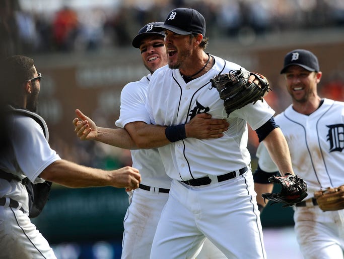 Tigers' closer Joe Nathan (35) celebrates as Alex Avila, far left, holds onto the final out for the Twins' in the ninth inning as Ian Kinsler, left, and Andrew Romine join him on the mound.
