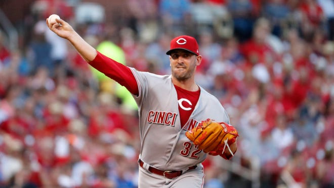 Cincinnati Reds starting pitcher Matt Harvey throws to first during the first inning of a baseball game against the St. Louis Cardinals Friday, July 13, 2018, in St. Louis.