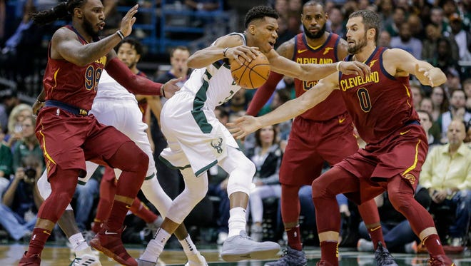 The Cavaliers surround the Bucks' Giannis Antetokounmpo during Friday night's game at the BMO Harris Bradley Center.