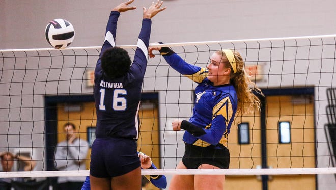 Eastside's Allie Wright (14) hits around Hilton Head's Da'Nesha Miller (16).    The Eastside Eagles  faced the Hilton Head Seahawks in the 3A Volleyball State Championship Saturday at White Knoll High School.