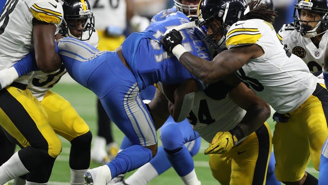 Lions running back Ameer Abdullah is tackled by the Steelers during the first quarter of Sunday's 20-15 loss on Sunday at Ford Field.