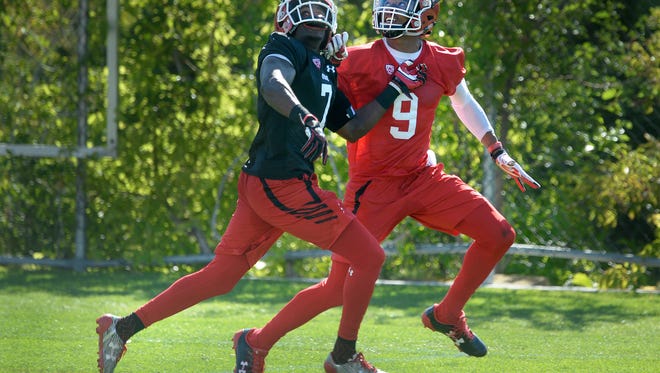 FILE - In this July 28, 2017, file photo, Utah wide receiver Darren Carrington II, right, looks back for the ball as he battles with defensive back Jaylon Johnson during the first day of NCAA college football practice in Salt Lake City. The idea of Utah taking the field with four receivers spread out and whipping the football around on a regular basis seems like a nightmare for coach Kyle Whittingham. But here the Utes are after the 13-year coach acknowledged that his grind-it-out philosophy had hit a wall in the offense-obsessed Pac-12. The college football world will get its first glimpse of the new, up-tempo system Aug. 31 when North Dakota travels to Salt Lake City.(Scott Sommerdorf/The Salt Lake Tribune via AP, File)