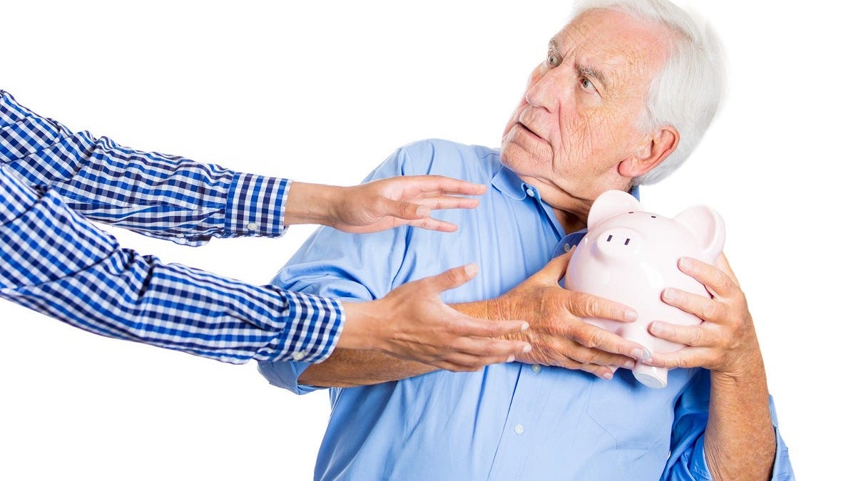 Man hanging onto a piggy bank as another person reaches out for it