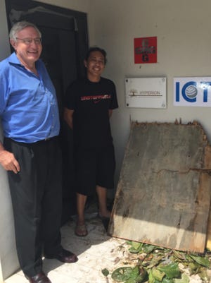 Richard Paverd, left, with ICT senior technician Bapi Ortego outside the ICT offices in Tortola, BVI.