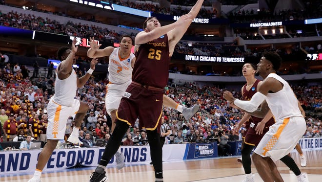 Loyola-Chicago center Cameron Krutwig (25) shoots after getting past Loyola-Chicago's Marques Townes, left, and Jake Baughman (2) during the second half of a second-round game at the NCAA men's college basketball tournament in Dallas, Saturday, March 17, 2018. (AP Photo/Tony Gutierrez)