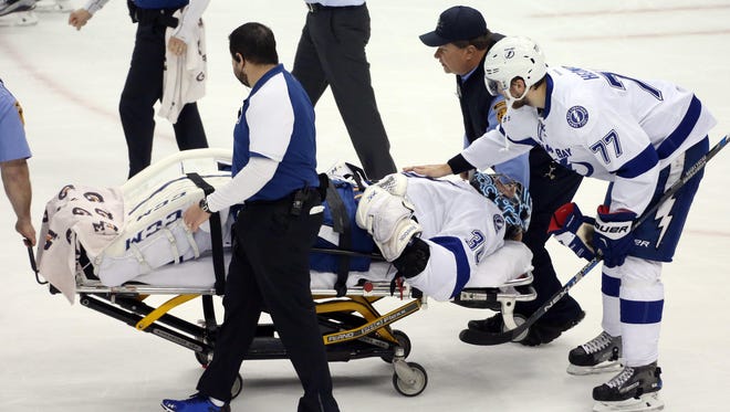 Tampa Bay Lightning goalie Ben Bishop (30) is taken off the ice on a stretcher in front of defenseman Victor Hedman (77) after suffering an apparent injury against the Pittsburgh Penguins during the first period in Game 1 of the Eastern Conference Final.