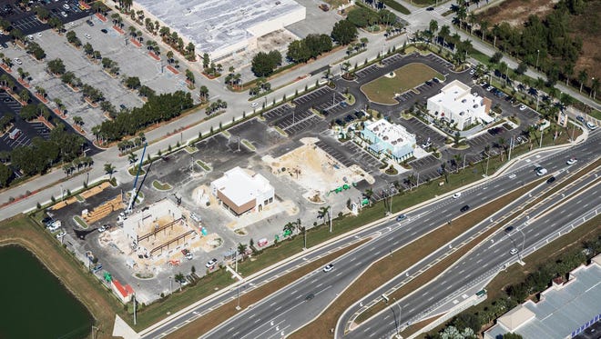 Restaurant Row is under construction along Collier Boulevard on the edge of Freedom Square shopping center. From left, Texas Roadhouse, Chipotle Mexican Grill and Pei Wei Asian Diner, a future sports bar, and now-open area drive-thrus for Pollo Tropical and Starbucks.