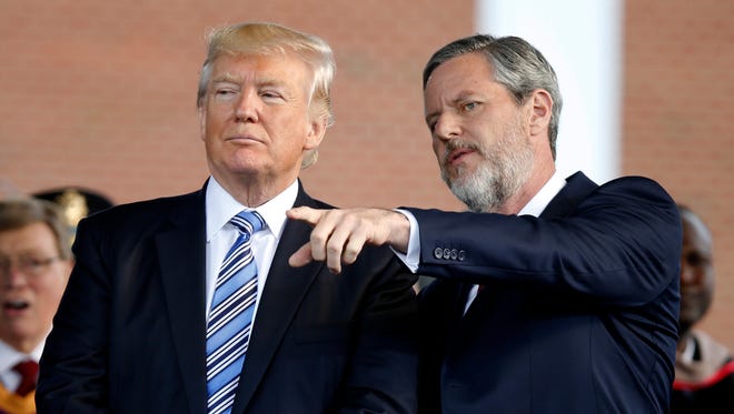 In this May 13, 2017 photo, President Donald Trump stands with Liberty University President Jerry Falwell Jr. in Lynchburg, Va.