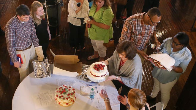 Karen Brittain, center, registers entries in the Strawberry Festival Recipe Contest on Tuesday at The Opera House in Humboldt, Tenn.