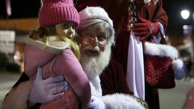 Five-year-old Jaci Walters meets Santa before the start of the 2015 Christmas Parade in downtown Milan. The 2016 Jackson Christmas Parade has been reset for Tuesday, Dec. 6, due to inclement weather in the forecast.