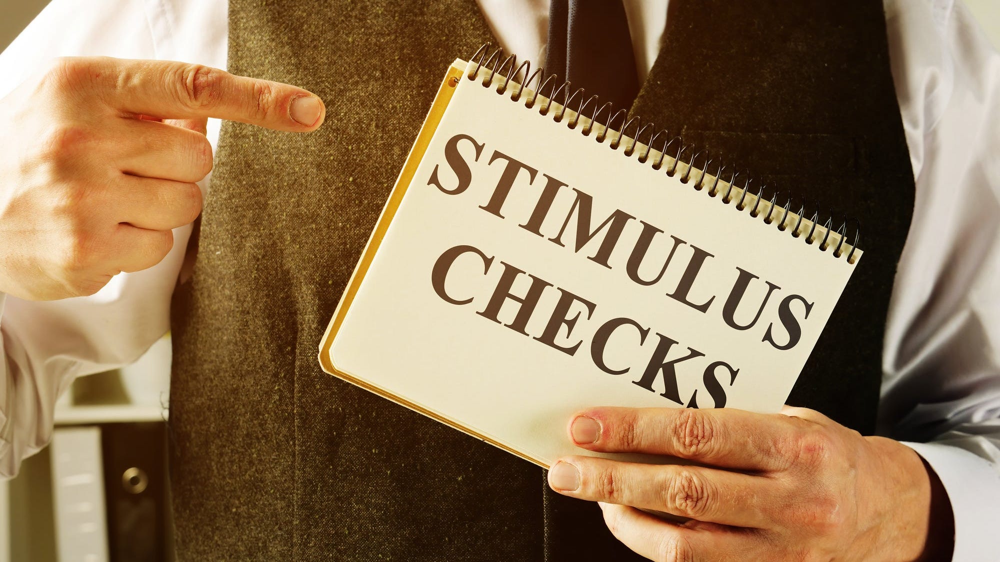 A man holds information about stimulus checks.