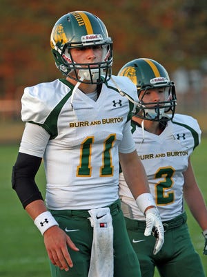 Burr and Burton quarterback Griff Stalcup, left, prepares for a snap during his team's Week 3 game against Milton.