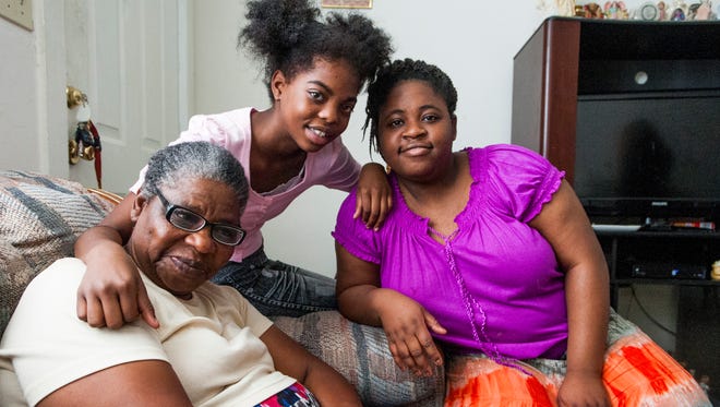 Rosa Bridges and her granddaughters Deja Goodson, center, and Joy Lynn in Bridges' small apartment in Montgomery, Ala. on Wednesday December 21, 2016.