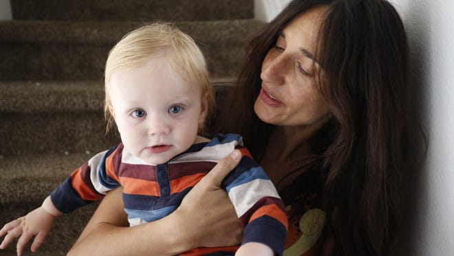 In this Thursday, Oct. 20, 2016, photo, vegan mother Fulvia Serra holds her 1-year-old son, Sebastiano, at home in Ft. Collins, Colo.