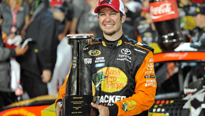 Martin Truex Jr. poses with the trophy after winning the NASCAR Sprint Cup series auto race Sunday at Charlotte Motor Speedway in Concord, N.C.