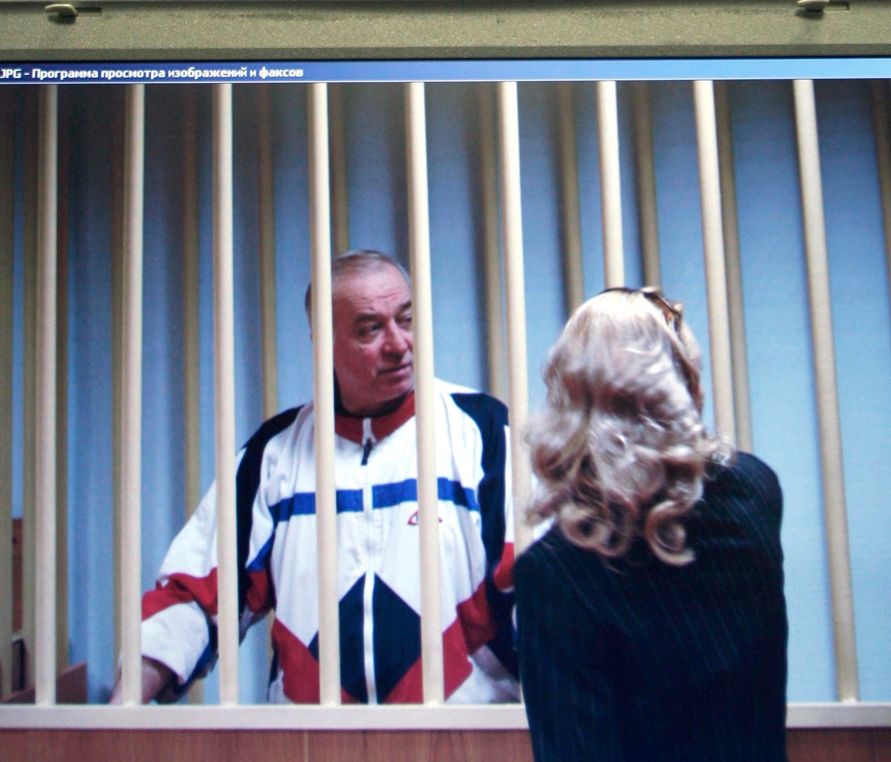 In this Aug. 9, 2006 photo, Sergei Skripal speaks to his lawyer from behind bars seen on a screen of a monitor outside a courtroom in Moscow. It has been reported on Monday, March 5, 2018 by the British media that Skripal is in critical condition aft