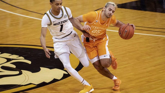 Tennessee's Santiago Vescovi, right, collides with Missouri's Xavier Pinson, left, as he brings the ball up court during the first half of an NCAA college basketball game Wednesday, Dec. 30, 2020, in Columbia, Mo.