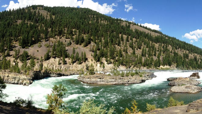Kootenai Falls is known for the swinging bridge visitors can cross over the water.