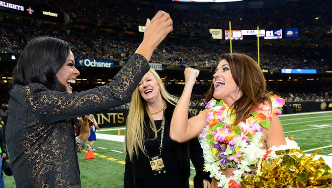 Tamica Lee, appearance team director for the Saintsations, congratulates Kriste Lewis on her selection to the 2017 Pro Bowl to represent New Orleans as team director Lesslee Fitzmorris looks on. The announcement was made at the New Orleans Saints vs. Los Angeles Rams game Nov. 27.