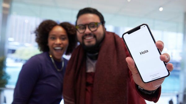 An Apple customer holding the iPhone X on launch...