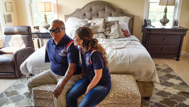 United States Marine veteran Ronny "Tony" Porta, wounded in Iraq in 2007, with his wife, Deicy Porta, in the master bedroom of his new "smart" home.