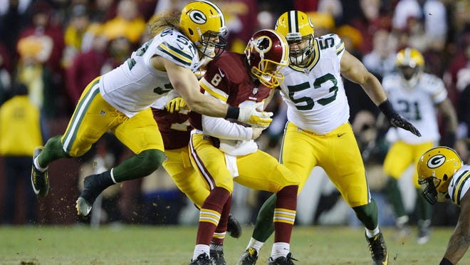 Jan 10, 2016; Landover, MD, USA; Green Bay Packers inside linebacker Clay Matthews (52) and Green Bay Packers outside linebacker Nick Perry (53) sack Washington Redskins quarterback Kirk Cousins (8) during the second half in a NFC Wild Card playoff football game at FedEx Field. Mandatory Credit: Brad Mills-USA TODAY Sports
