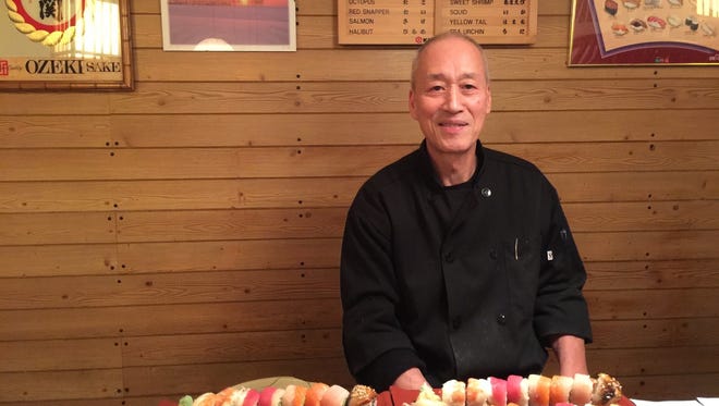 Sakura Sushi owner Kenji Tanaka with a jumbo order of rainbow roll.