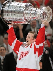 Red Wings captain Steve Yzerman holds the Stanley Cup