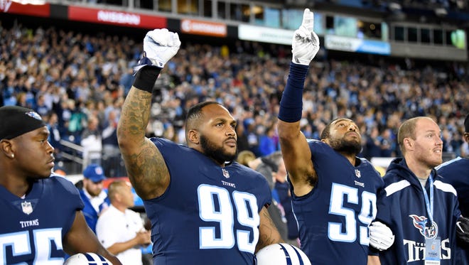 Titans defensive tackle Jurrell Casey (99) and linebacker Wesley Woodyard (59) during the national anthem at Nissan Stadium on Monday, Oct. 16, 2017, in Nashville