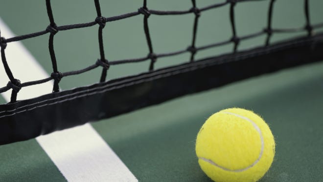 Close-up of a tennis ball and net on a tennis court