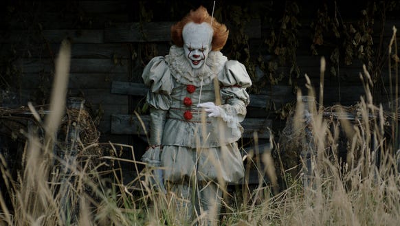 Bill Skarsgård lurks as the evil Pennywise in 'It.'