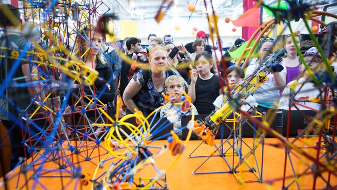 Maureen and Liam Foster of Clay, NY look at amusement rides made out of K'Nex during Imagine RIT on May 2, 2015.