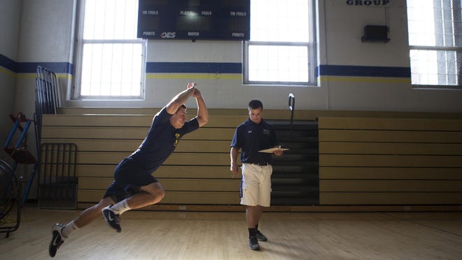Matt Krempholtz with University of Rochester Sports Medicine watches as Brighton High School junior, Austin Carr, does a single leg jump during a sports camp on Saturday, May 30, 2015.