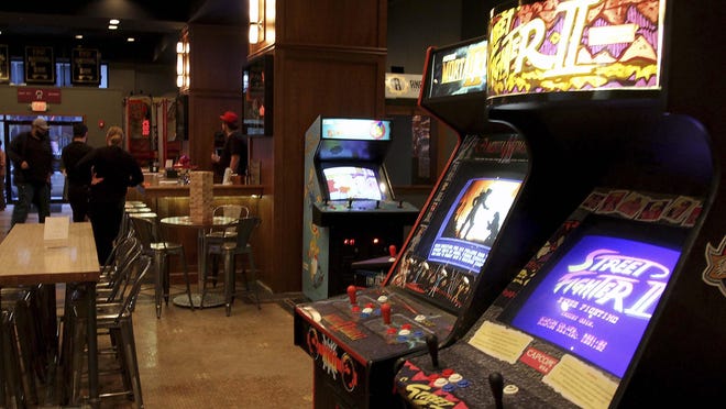 A variety of video games take up the space formerly held by banks and a jeweler in Analog Arcade Bar in Davenport.