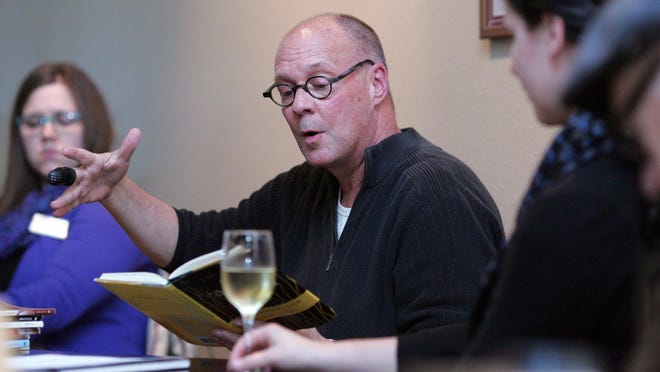 David Baker, Thomas B. Fordham chair at Denison University, shares some of his poems Wednesday night with guests at Palumbo’s Italian Market & River Road Coffeehouse on the Square.