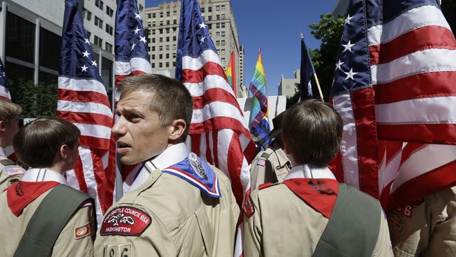 Boy Scouts from the Chief Seattle Council prepare to march in the Gay Pride Parade in Seattle in 2013. The BSA leadership decided in 2013 to allow participation by openly gay youth. Then in 2015 it also eased its ban on gay adults serving as paid staff or volunteers.