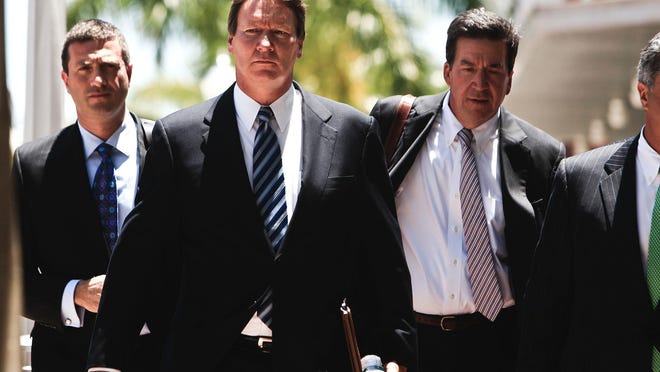 Jerry Williams, the ex-CEO of Orion Bank, second from left, walks into his sentencing at the federal courthouse in Fort Myers on Tuesday June 12, 2012.