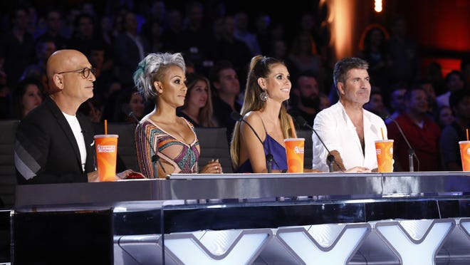 In this Tuesday, Aug. 22, 2017 photo provided by NBC, judges Howie Mandel, Mel B, Heidi Klum and Simon Cowell participate in a live broadcast of "America's Got Talent" in Los Angeles.