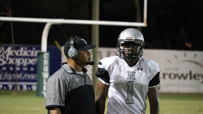Northwest High coach Chris Edwards discusses strategy during a game last season at Crowley High.