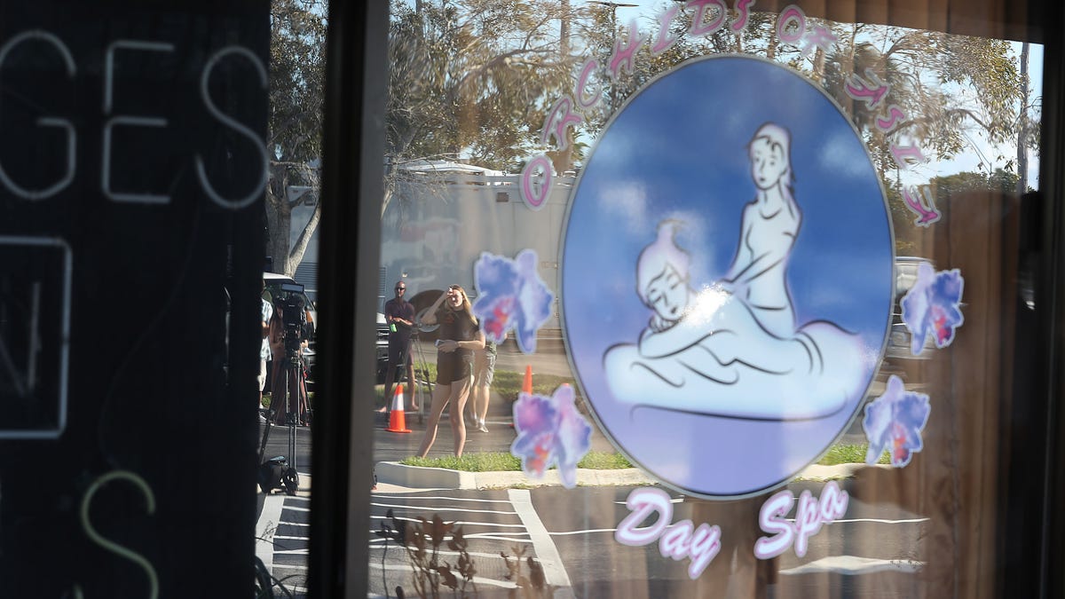 JUPITER, FLORIDA - FEBRUARY 22: People are reflected in the window of the Orchids of Asia Day Spa after New England Patriots owner Robert Kraft is charged with allegedly soliciting for sex on February 22, 2019 in Jupiter, Florida. Mr. Kraft was caught up in a law enforcement operation in South Florida that netted hundreds of johns over the past two weeks.(Photo by Joe Raedle/Getty Images) ORG XMIT: 775303799 ORIG FILE ID: 1131462322
